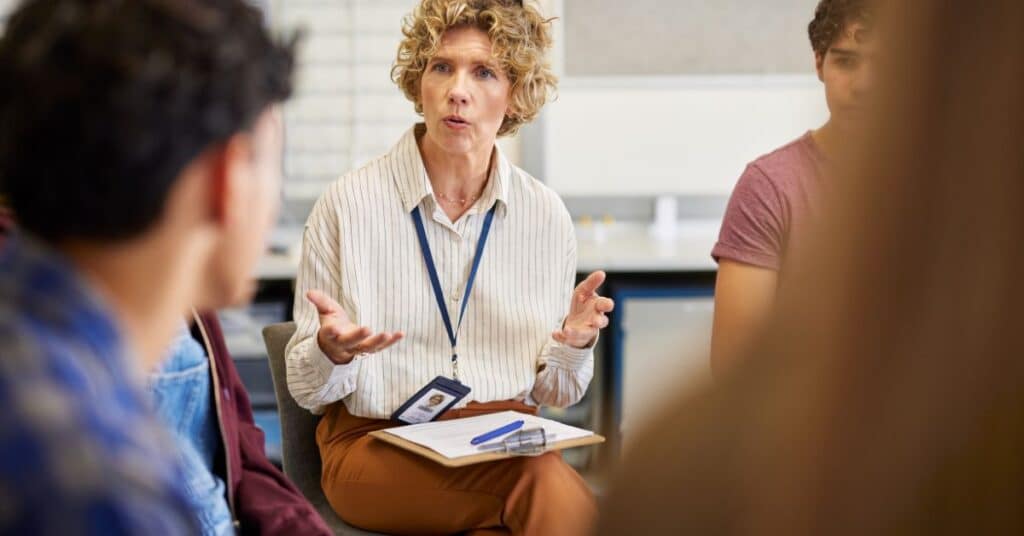 Counsellor speaking with a group of people during a group discussion